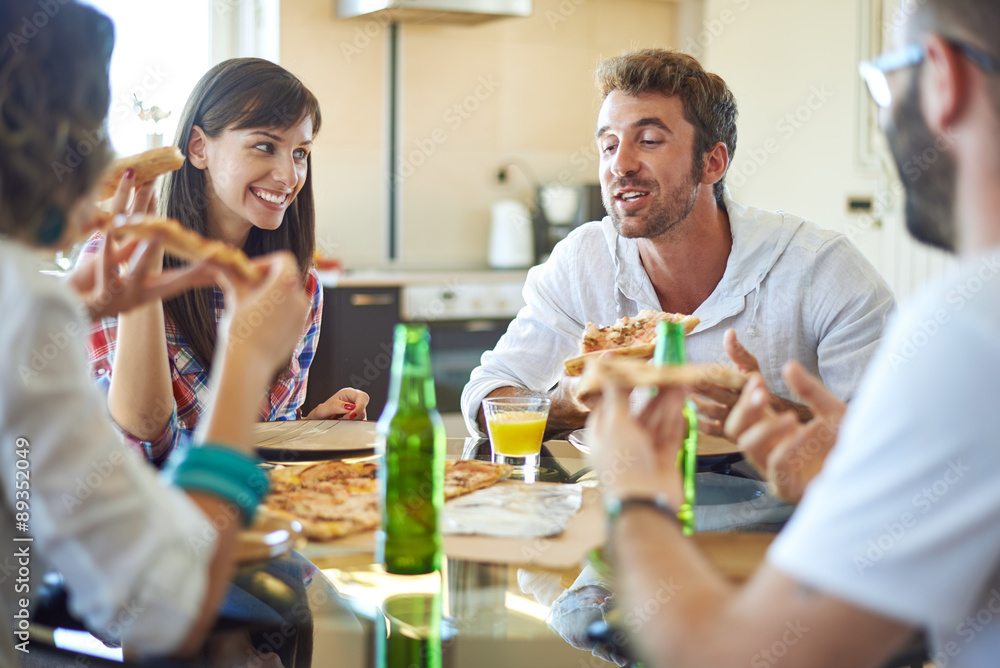 Two couples eating pizza