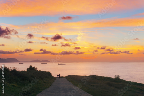 couple walking in park in Getxo with beautiful sunset