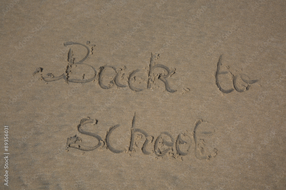 Fototapeta premium Back to school written in sand