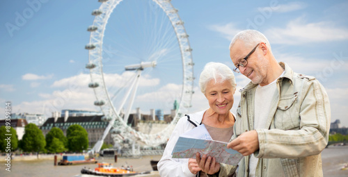 Photography senior couple with map over london eye