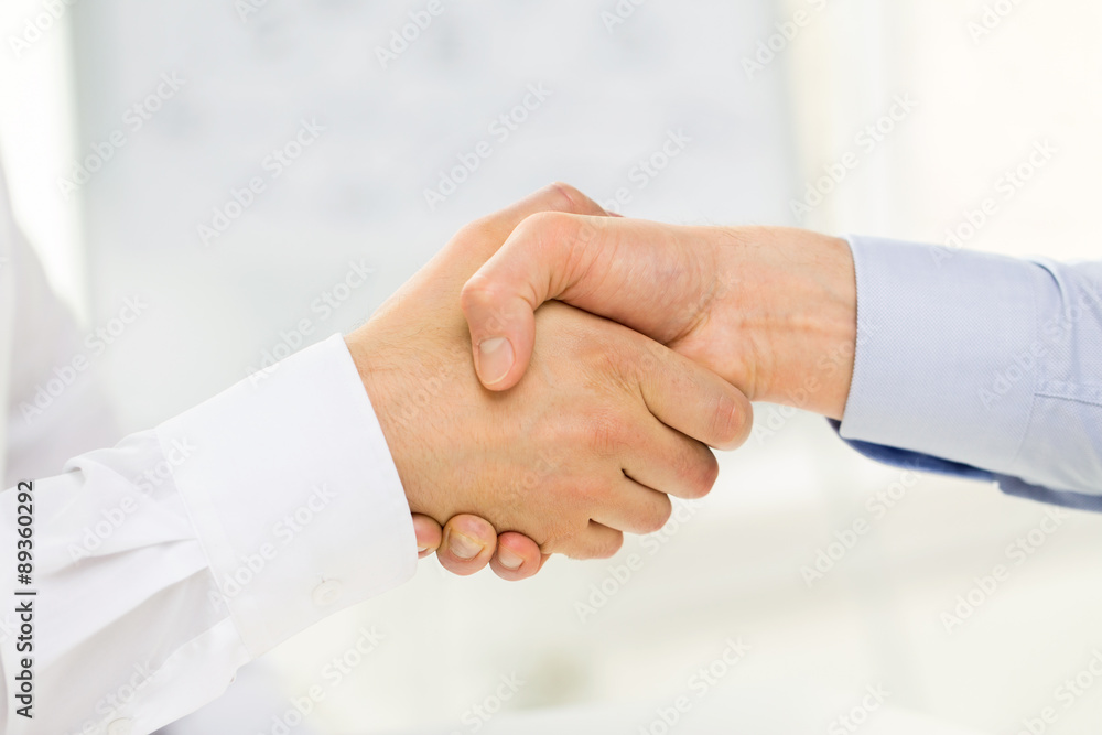 close up of hands making handshake in office close up of hands making handshake in office