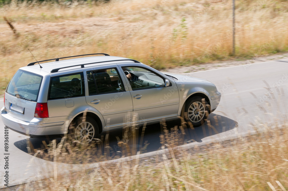  car driving at high speed in empty road