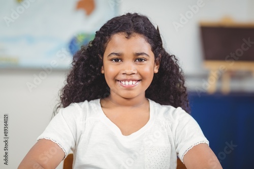 Smiling pupil sitting in a classroom