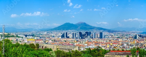 aerial view of centro direzionale business district in naples with mount vesuvius behind.