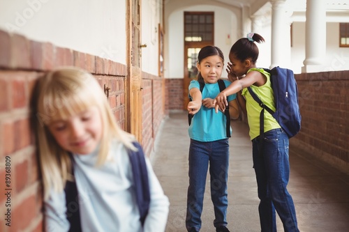Fotografie Sad pupil being bullied by classmates at corridor