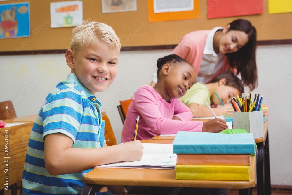 Smiling teacher helping a student Smiling teacher helping a student