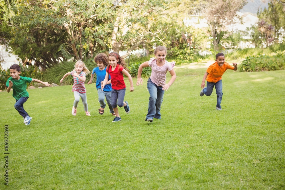 Fototapeta premium Children running on the grass