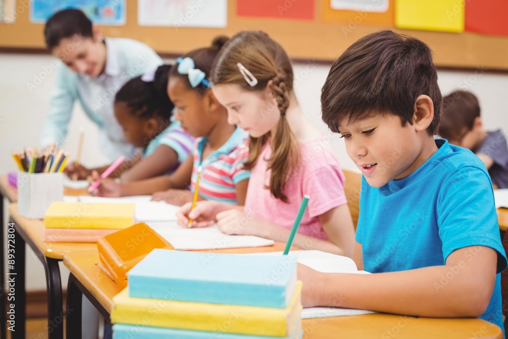 Pupils working at their desks in class Pupils working at their desks in class