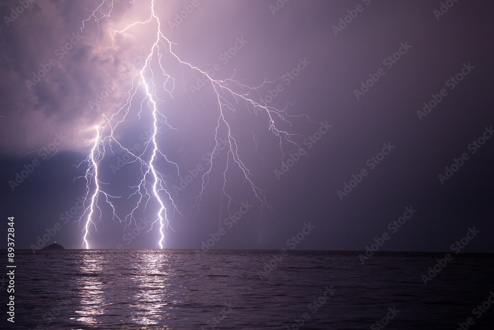 Spectacular lightnings striking the sea during the night