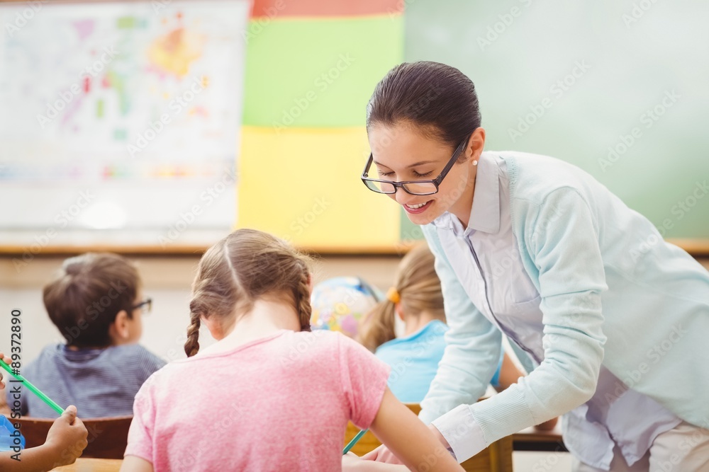 Teacher helping a pupil during class Teacher helping a pupil during class