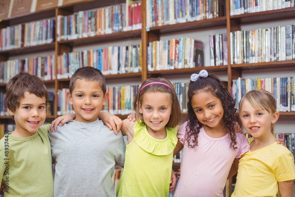 Pupils smiling at camera in library
