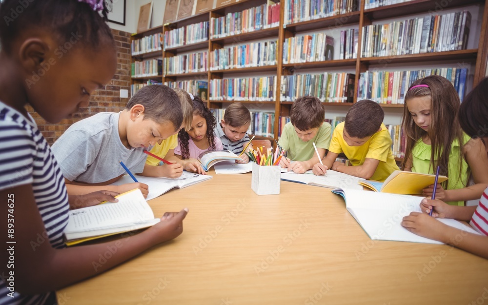 Pupils working together at desk in library Pupils working together at desk in library