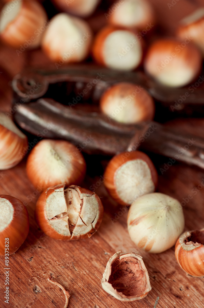 Cracking hazelnuts on wooden table closeup. Organic food, Healthy eating. Cracking hazelnuts on wooden table closeup. Organic food, Healthy eating.