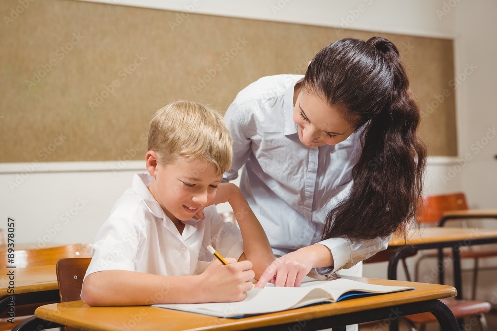 Teacher helping a student in class Teacher helping a student in class