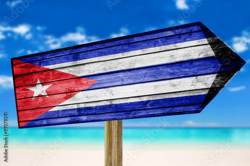 Cuba Flag wooden sign with beach background photo