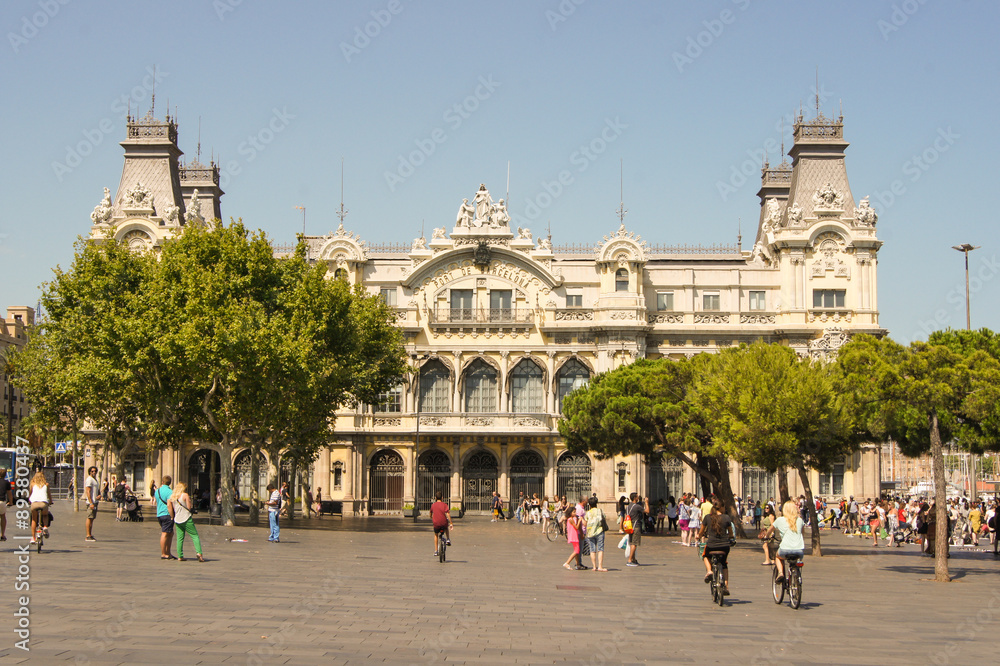 Barcelona, Spain - August 1, 2015.
People in the square in front of the port of Barcelona.