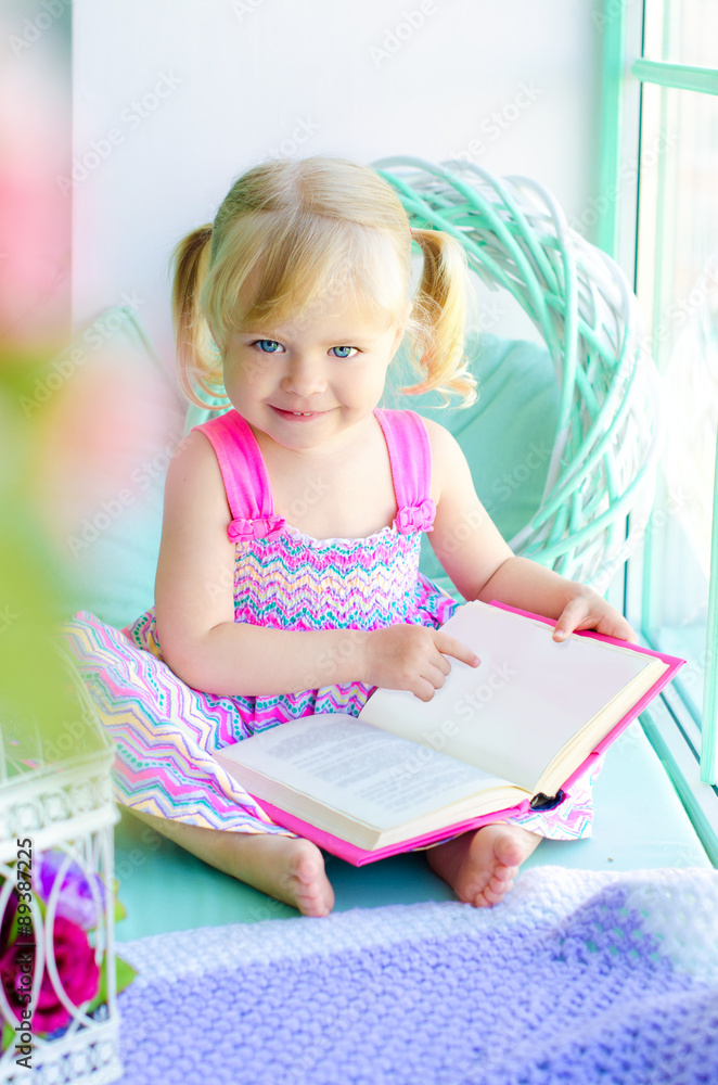 little funny girl reading book near window little funny girl reading book near window