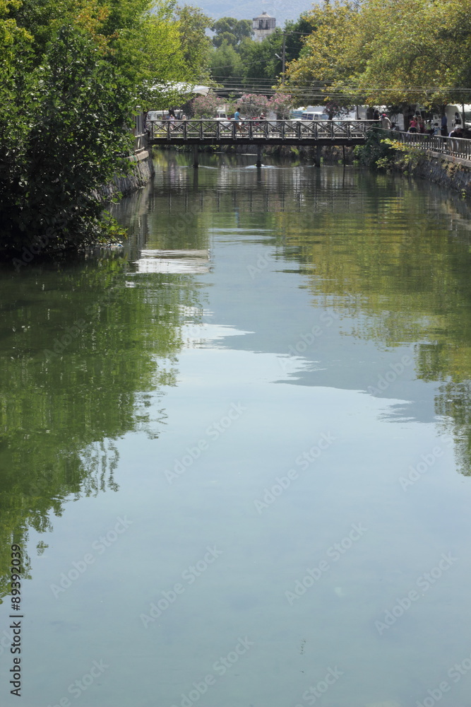 A Turkish water way with a bridge in the town of fethiye in turkey