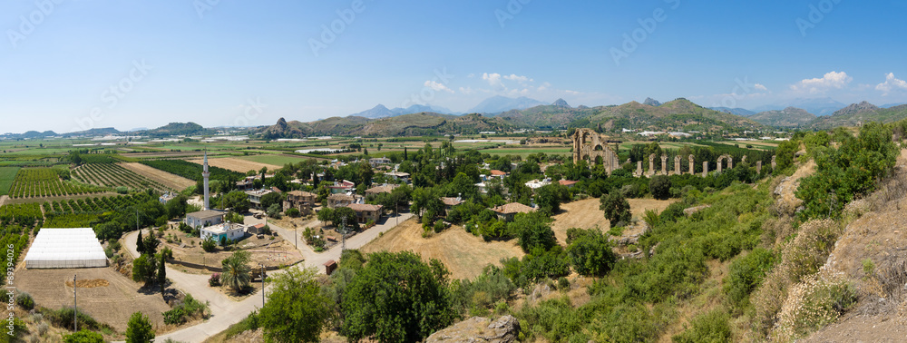 Ancient ruins of Aspendos. In the background the aqueduct. Panorama. Turkey.