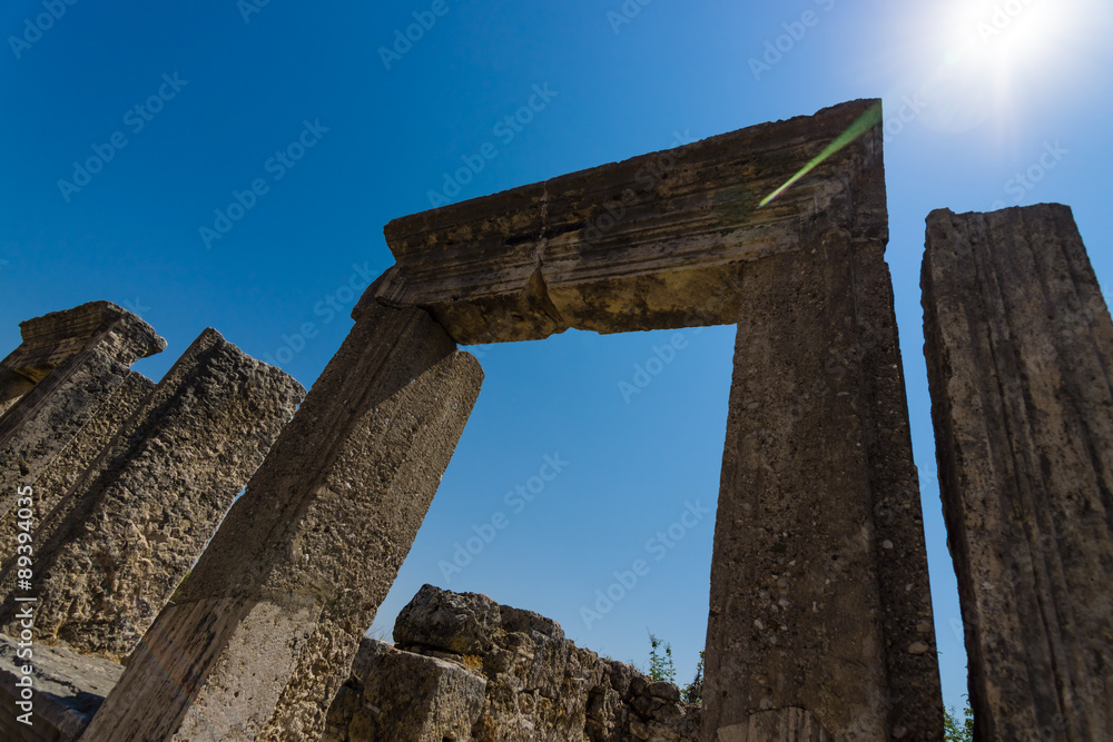 Ancient ruins of Perge on a background of blue sky. Optical glare from the sun. Turkey.