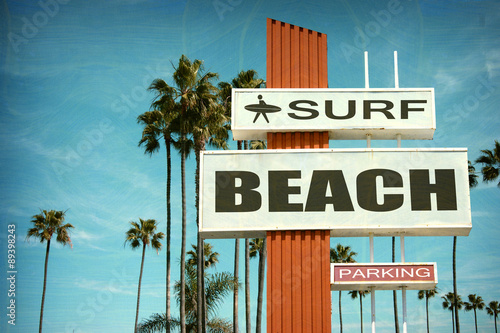 Obraz w wieku i zużyte archiwalne zdjęcie znak plaży surfowania z palmami