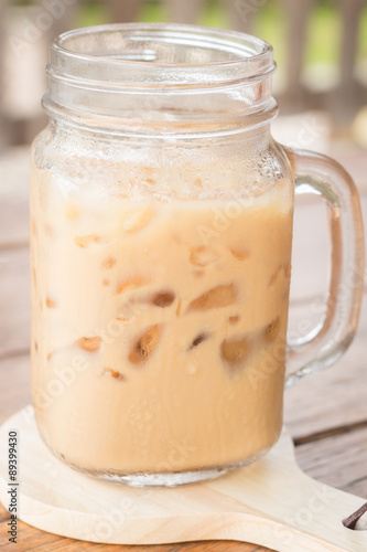 Iced milk coffee on wooden table