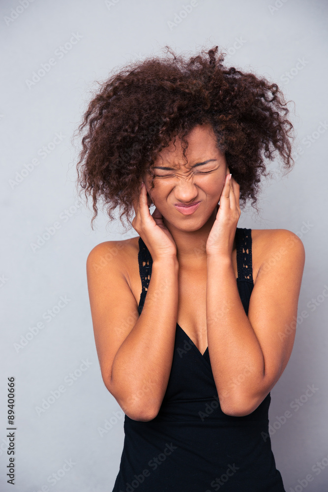 Afro american woman covering her ears Afro american woman covering her ears