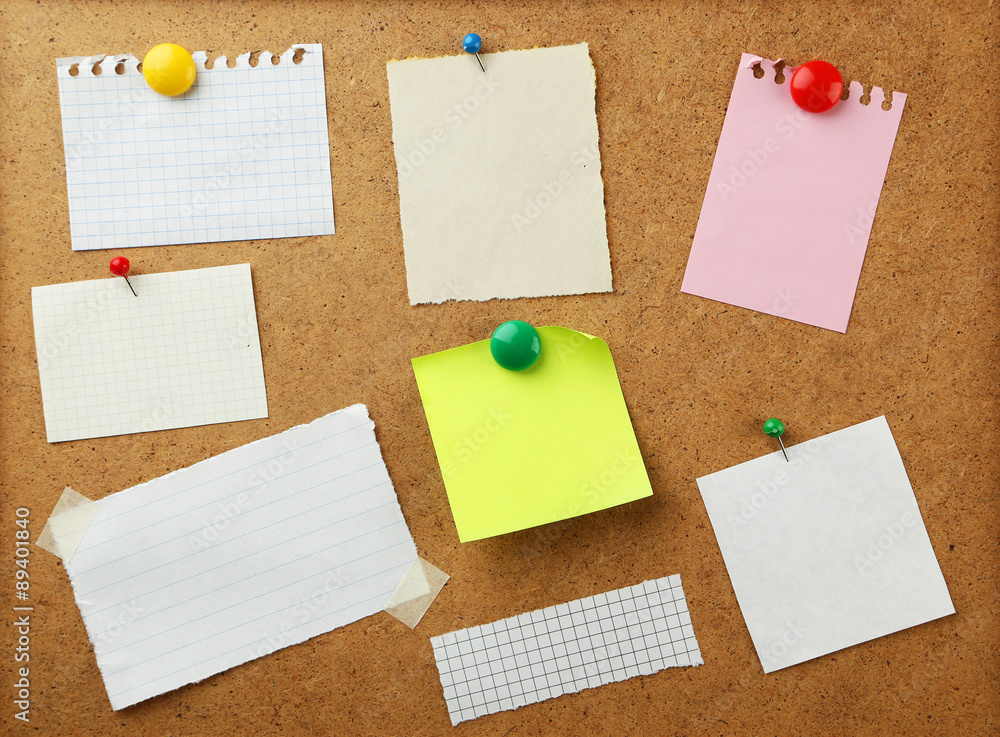 Pieces of note paper on brown background Pieces of note paper on brown background