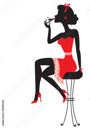Woman is sitting and drinking martini in red dress on white #89402250