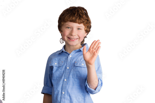 Handsome smiling boy waving with his hand. Isolated on white