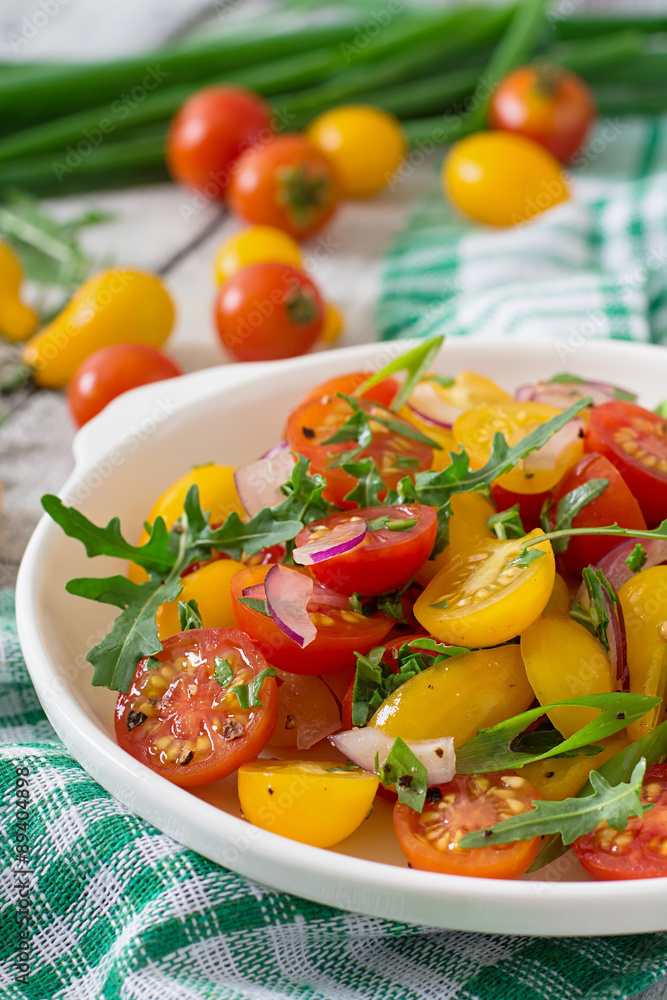 Salad of fresh cherry tomatoes with onion and arugula Salad of fresh cherry tomatoes with onion and arugula