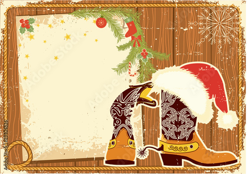 Billboard frame with cowboy boots and Santa's red hat on wood wa