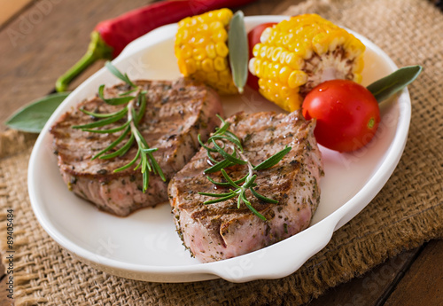 Tender and juicy veal steak medium rare with vegetables