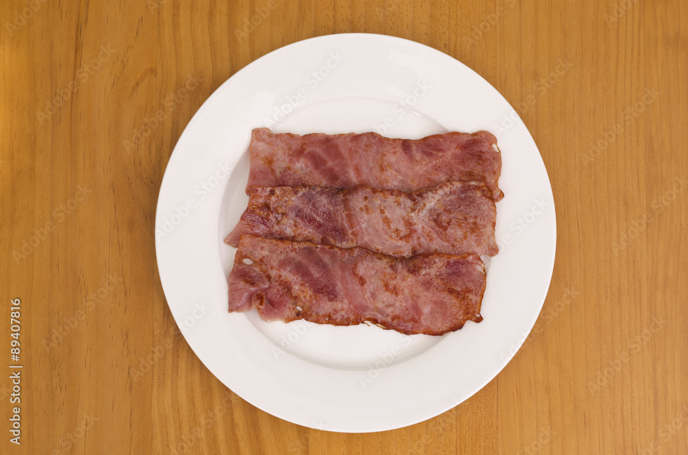 Fried bacon strips on plate