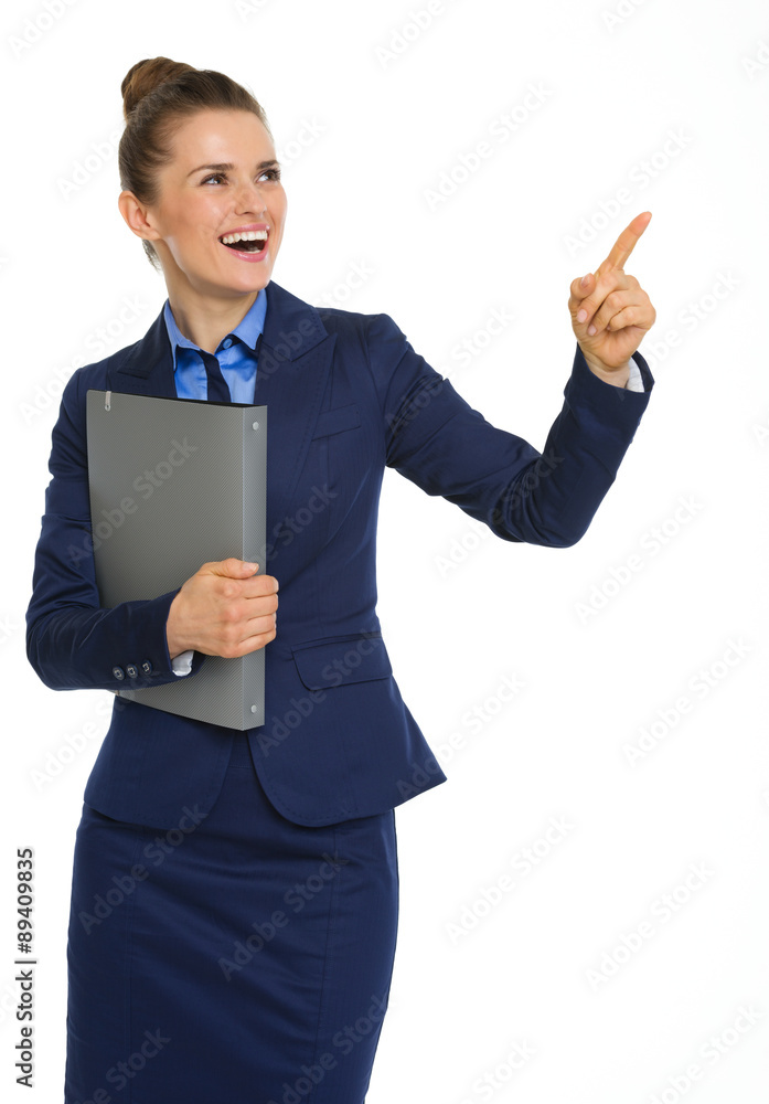 Happy businesswoman holding file, pointing upwards, and smiling Happy businesswoman holding file, pointing upwards, and smiling