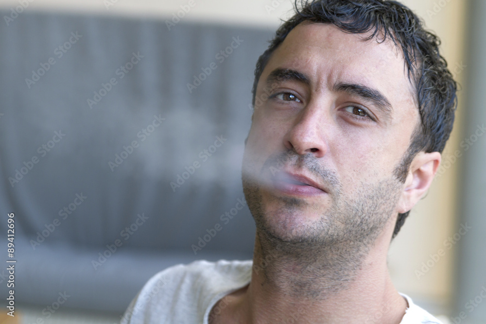 Attractive man smoking a cigarette Attractive man smoking a cigarette