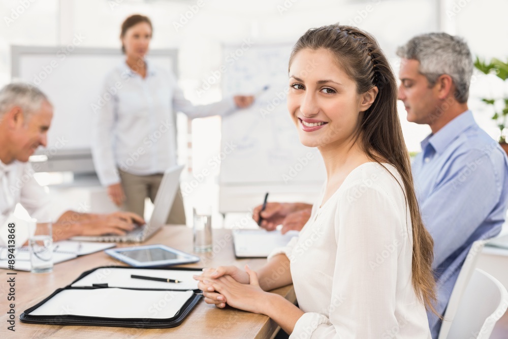 Smiling businesswoman during a presentation Smiling businesswoman during a presentation