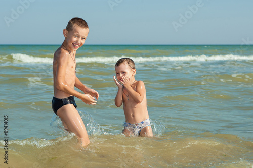 Happy  Children - two boys having fun on the beach