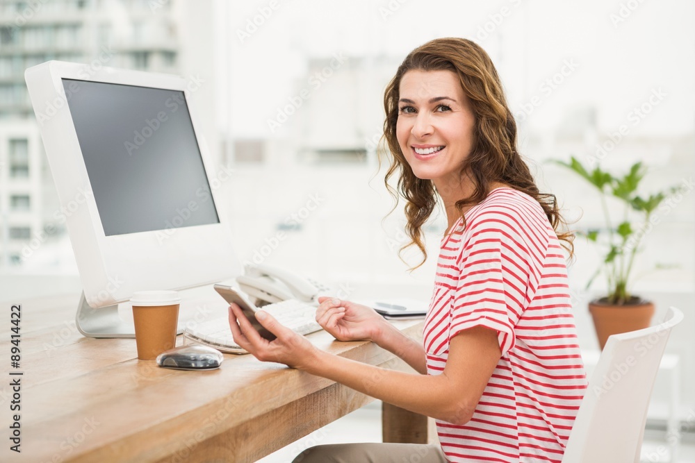 Smiling casual businesswoman using smartphone Smiling casual businesswoman using smartphone