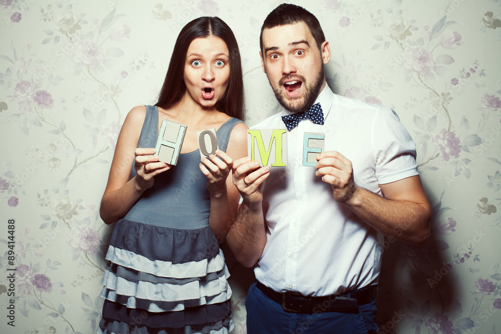 Home sweet home concept. Portrait of funny, happy hipsters Home sweet home concept. Portrait of funny, happy hipsters
