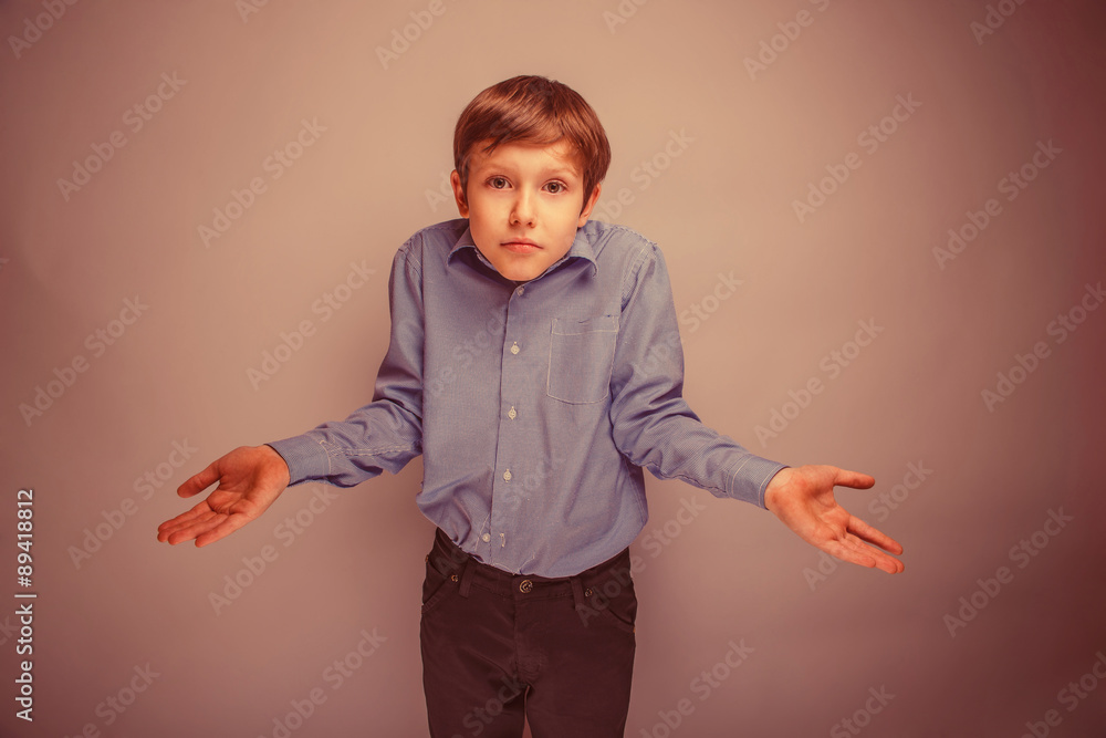 boy teenager of European appearance brown hair threw up his hand