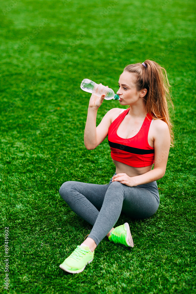Beautiful Smiling Woman Relaxing on the Grass in the Park During Beautiful Smiling Woman Relaxing on the Grass in the Park During
