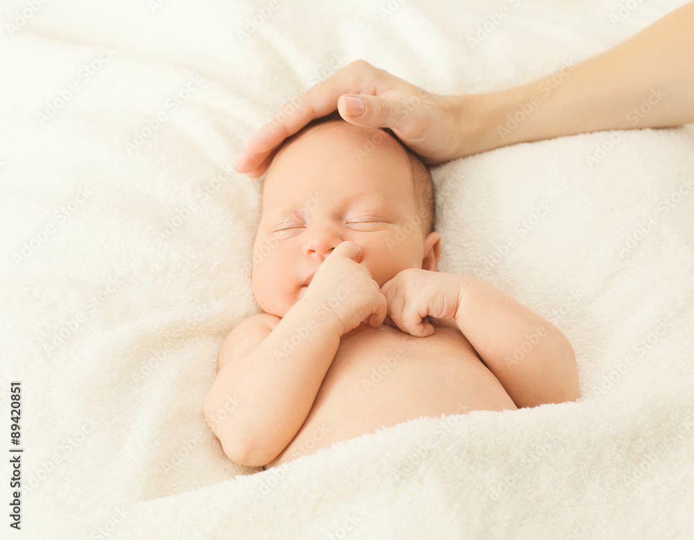 Portrait cute baby sleeping on the bed under blanket and affecti Portrait cute baby sleeping on the bed under blanket and affecti