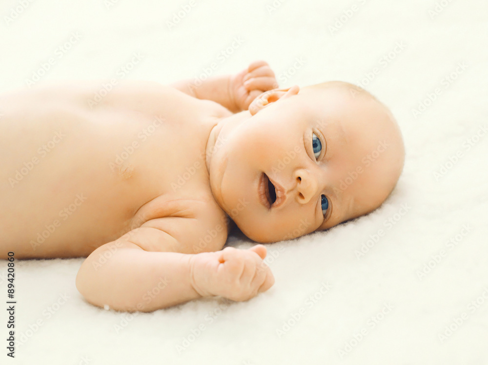 Closeup portrait of infant lying on the bed at home Closeup portrait of infant lying on the bed at home