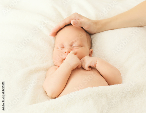 Portrait cute baby sleeping on the bed under blanket and affecti