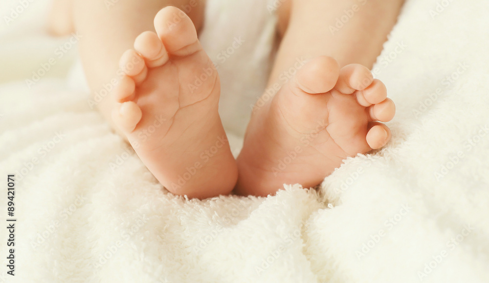 Soft photo closeup comfort baby feet on the bed at home Soft photo closeup comfort baby feet on the bed at home