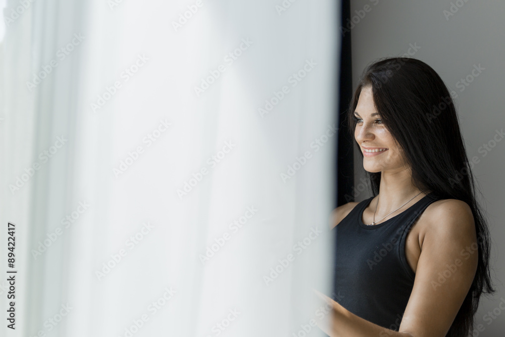 Happy beautiful woman staring out the window Happy beautiful woman staring out the window
