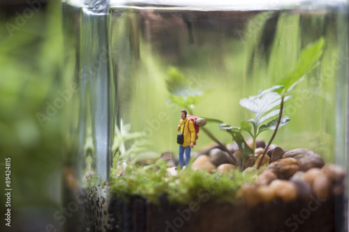 A closed terrarium decorated with a camping man.
