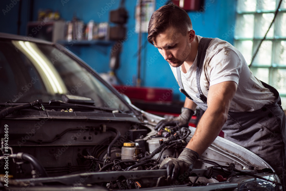 Worker of service station repairing Worker of service station repairing