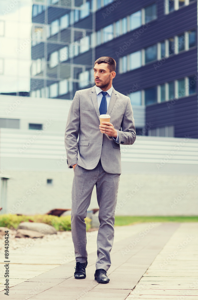 young serious businessman with paper cup outdoors young serious businessman with paper cup outdoors